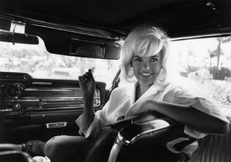 Jayne Mansfield sits in the passenger seat of a limousine, circa 1965.